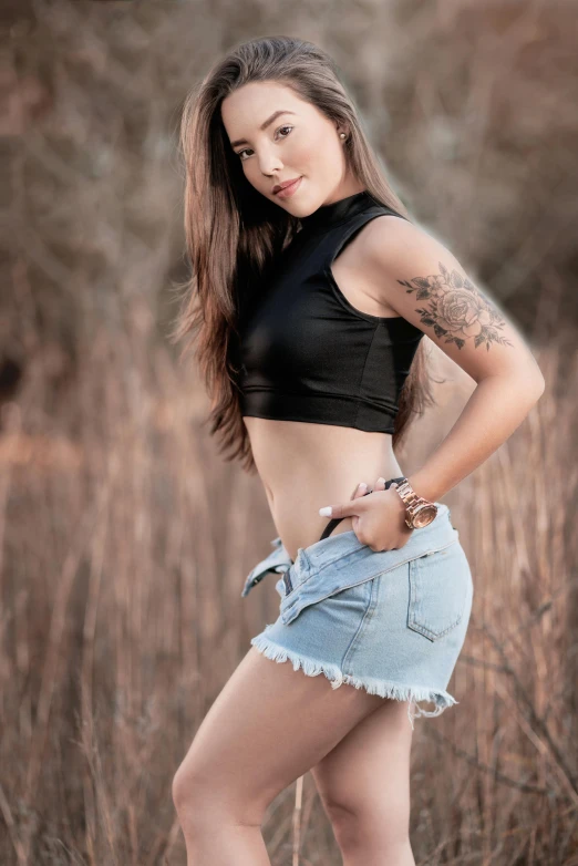 a young lady posing for a studio pograph in a field