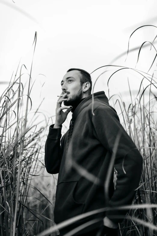 a man with a jacket and tie talking on a cellphone