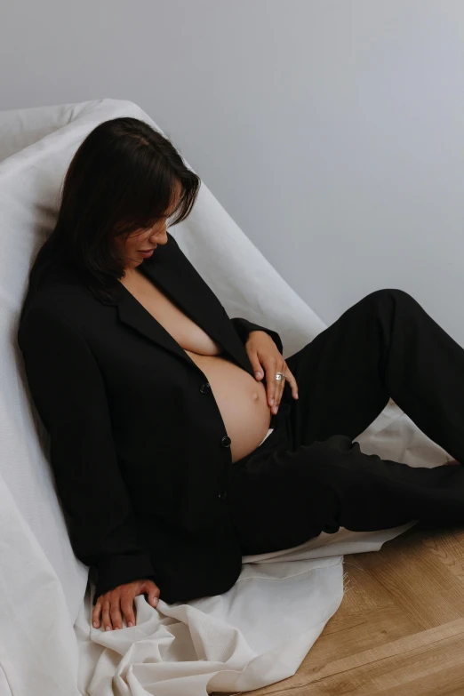 a women with long dark hair sitting on the bed