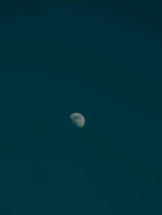 a large moon is shown against a dark sky