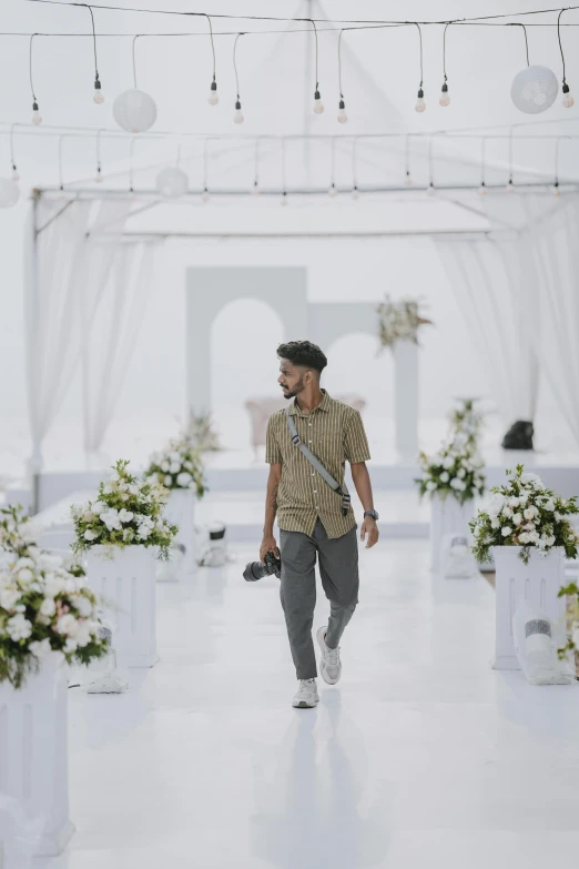 a man is walking down the runway dressed in plaid shirt