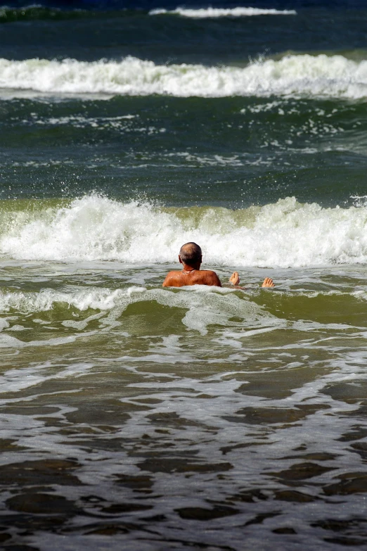 two people floating in the water with their surf boards