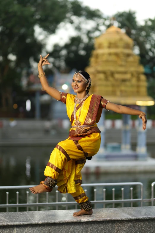 a man standing on a ledge wearing a yellow outfit