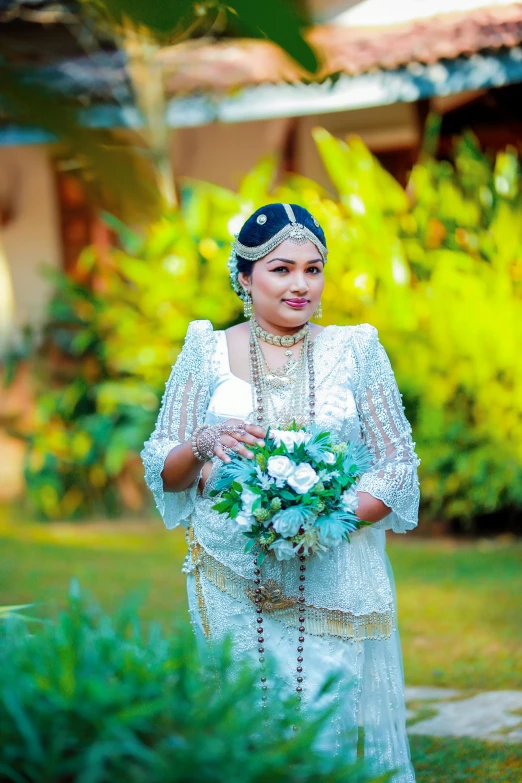 the woman is wearing a bridal look with flowers and leaves in her hair