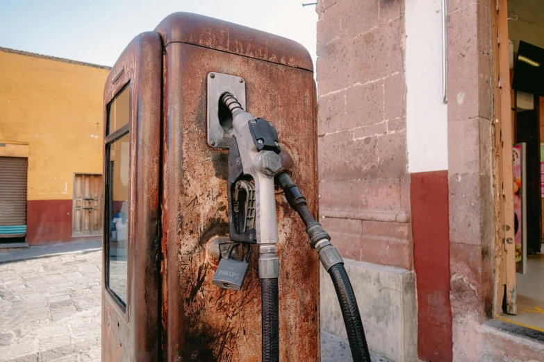 a gas pump in front of a brick building