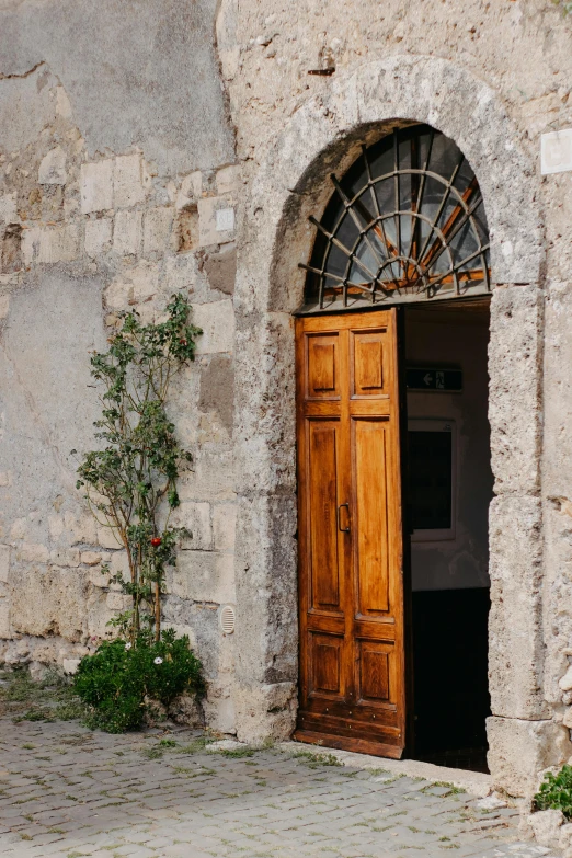 an old stone building with wooden door and windows