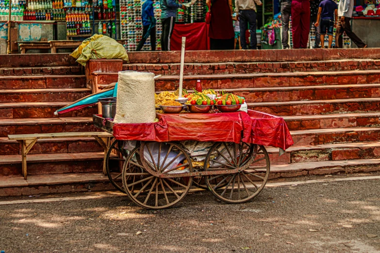 a small cart sitting outside of a store near some steps