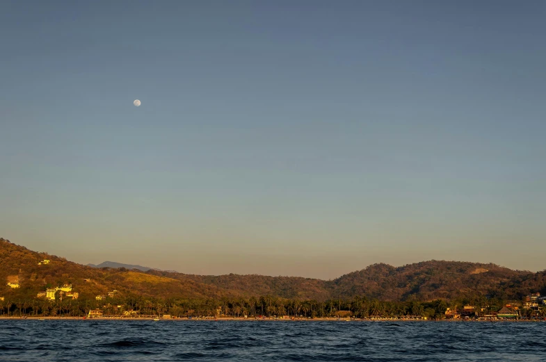 some sailboats are sailing in a large body of water