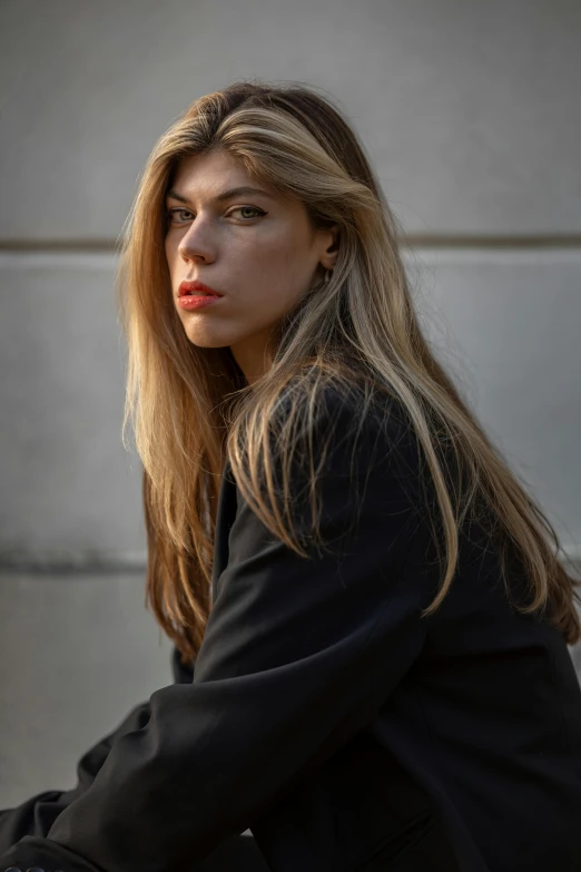 the beautiful young woman is posing in front of a building