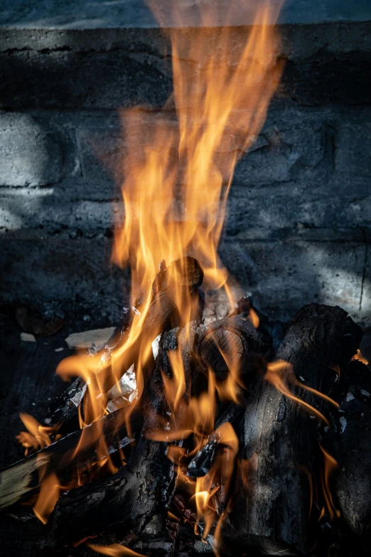 fire flames out in the dark on a stone fire pit