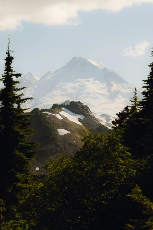 the snow capped mountain is covered with thick clouds