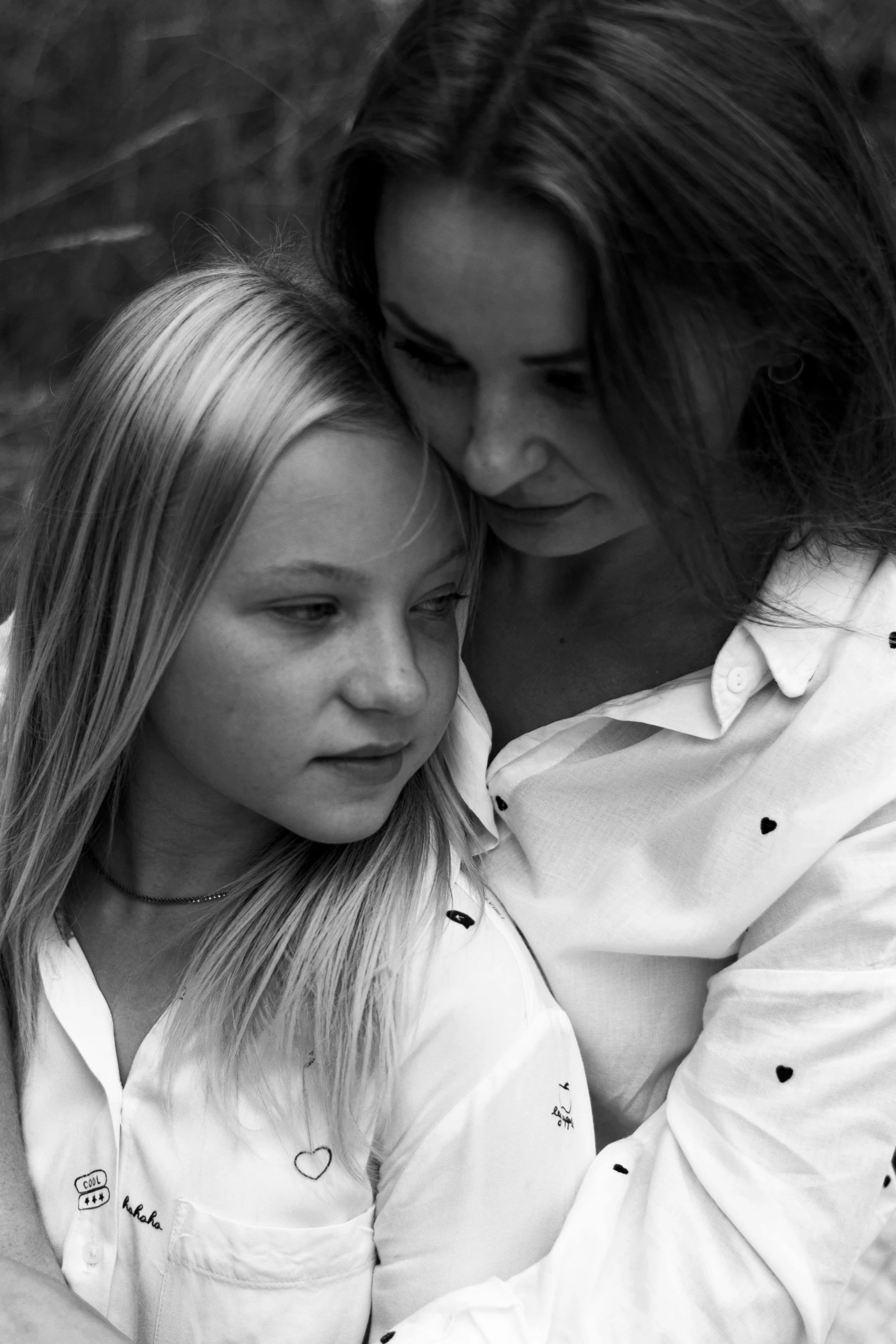 two young women are emcing one another on the ground