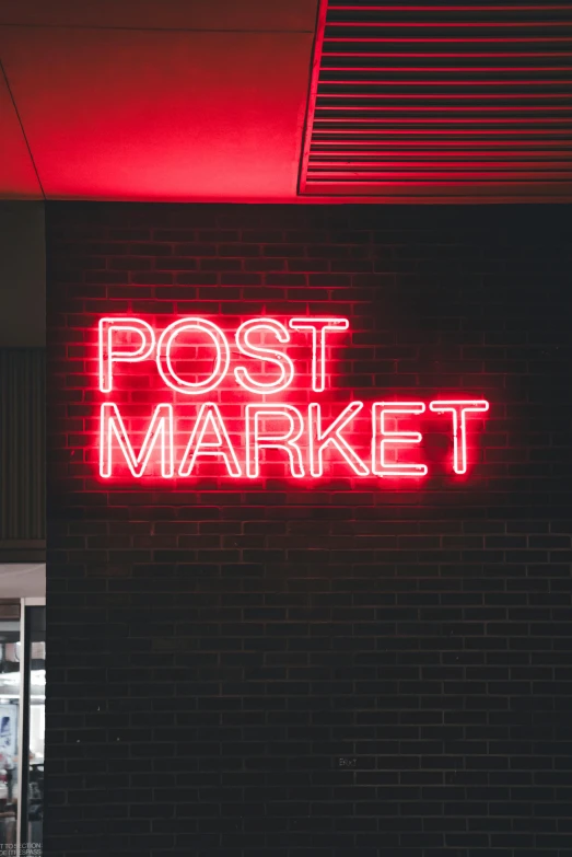 a red neon sign on the side of a building