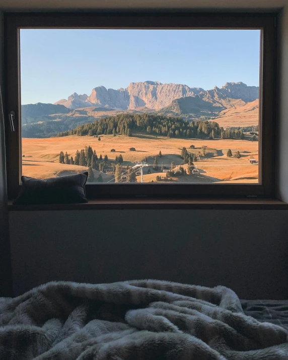 a view of some mountains from a window