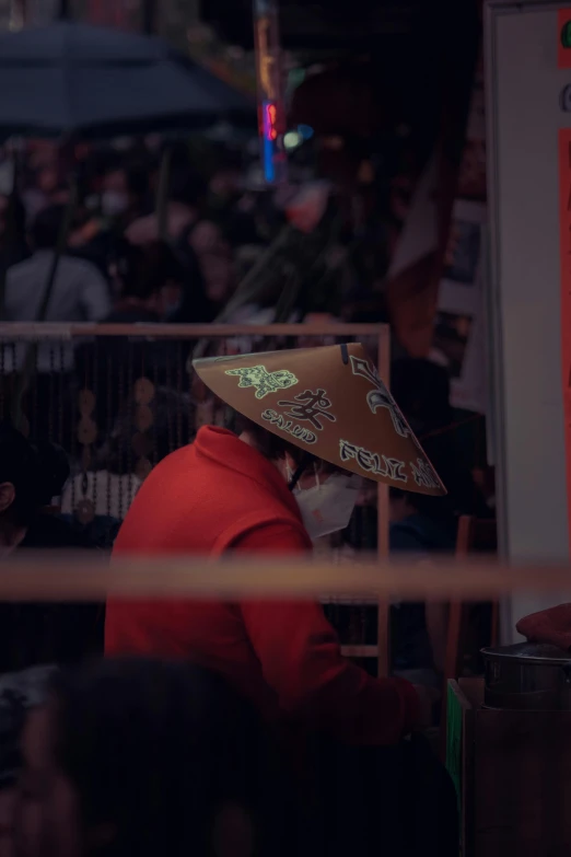 the man wearing a large hat stands outside