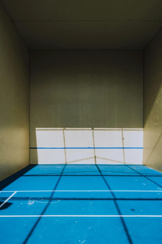 a shadow of a tennis court is shown on the ground