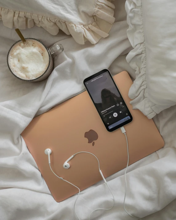 a cell phone sits on an apple laptop