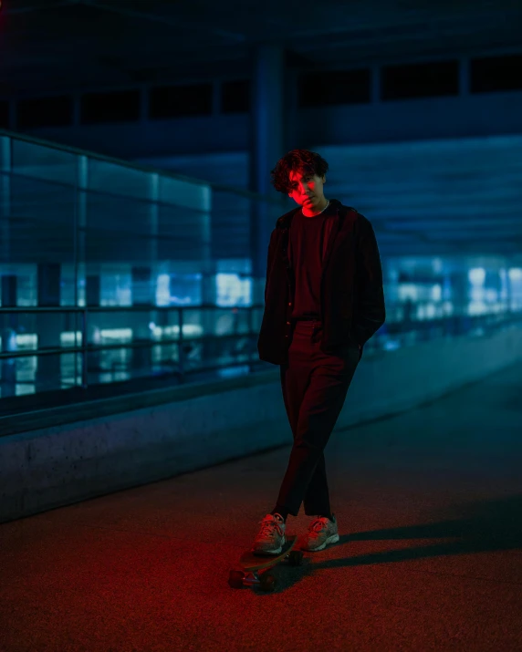 a boy on a skateboard in a dark parking lot