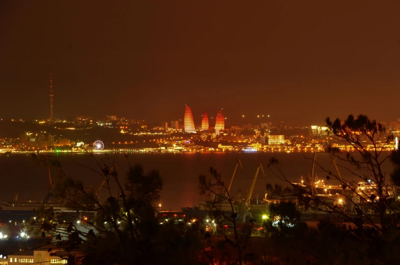 a city skyline with lights in the dark