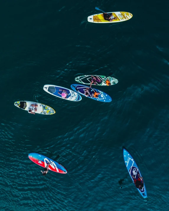 a group of people in a body of water with surf boards