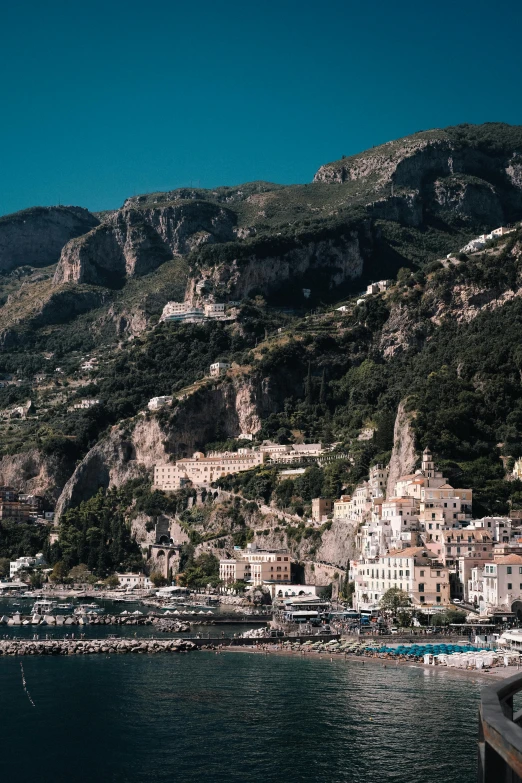 boats are in the water by a mountain side