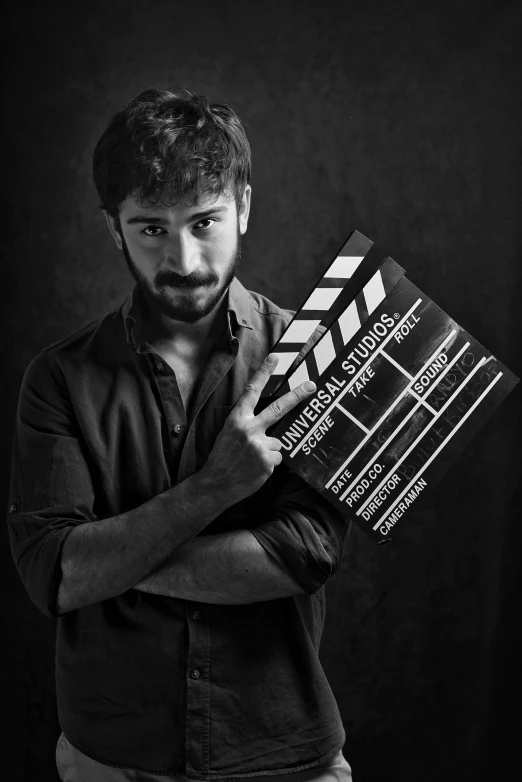 a man holding a book that reads how to use a camera