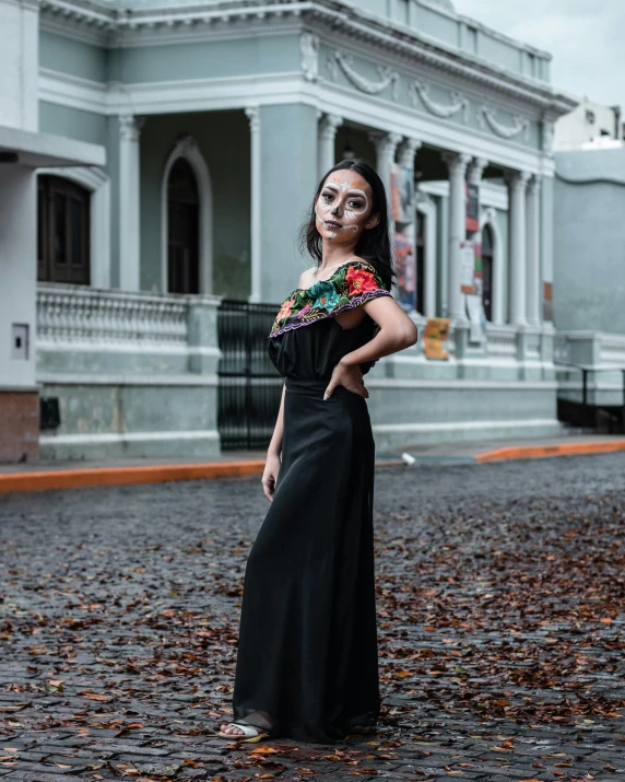 a woman with an umbrella and makeup standing on the street