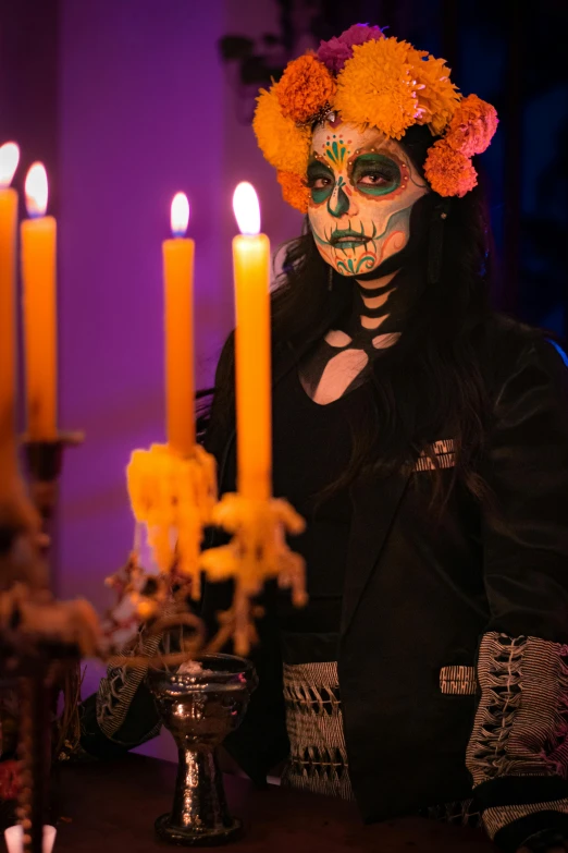 a girl dressed up in a sugar skull costume and day of the dead makeup