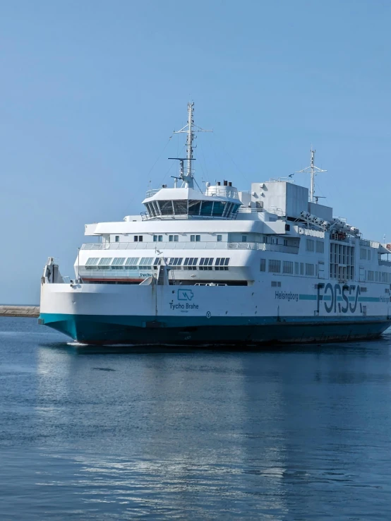 a large white and blue boat docked at a pier