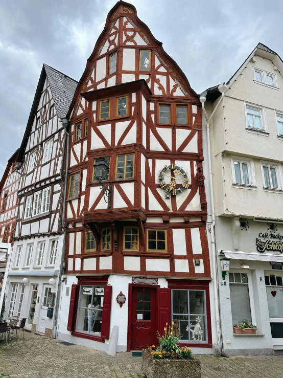 a house with half timber timber is standing between several old buildings