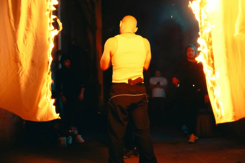 a person standing in front of many lit torches