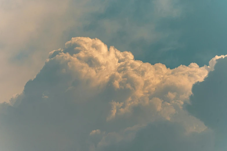 two airplanes fly under a partly cloudy sky