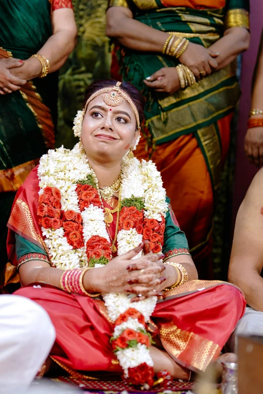 a woman dressed in flowery clothing is standing next to a crowd