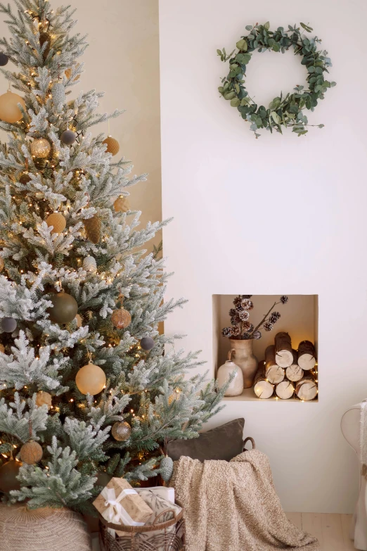 a christmas tree with an wreath mounted on the wall and a fireplace mantle