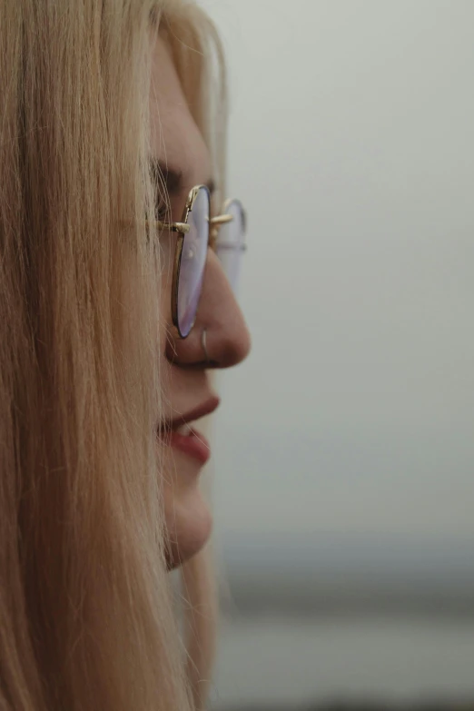 a blond haired woman with glasses on her face