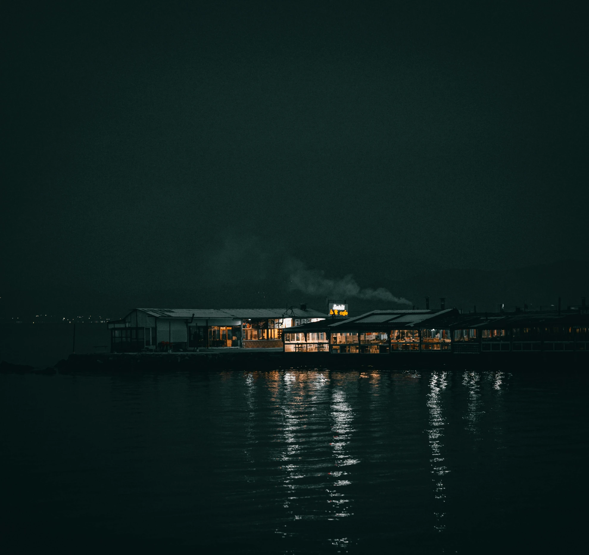 the dock in a darkened place has many lights