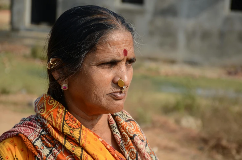 a woman in her indian dress posing for the camera