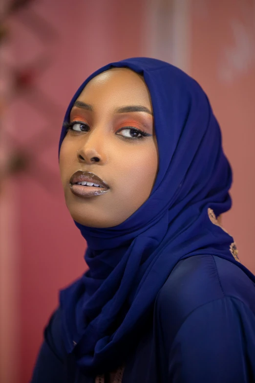 a woman with a dark blue head covering