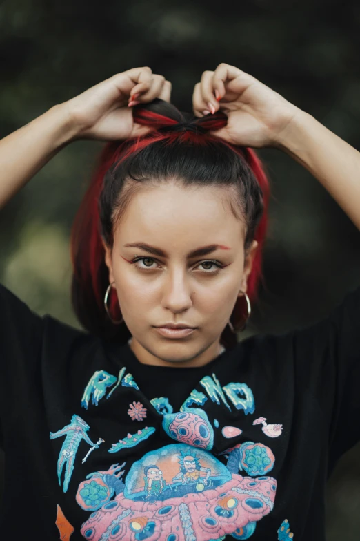 a woman with red hair has one hand on her head