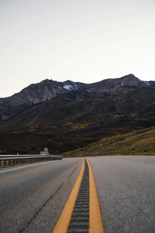 the view of the mountain and road from a moving vehicle