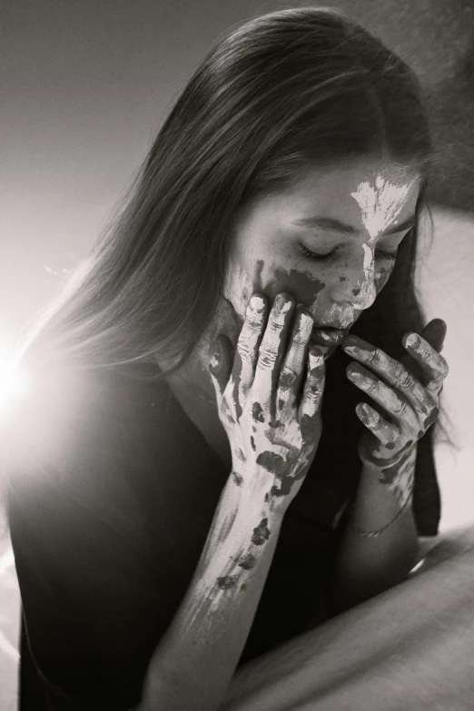 a woman covering her face with a powdered sugar