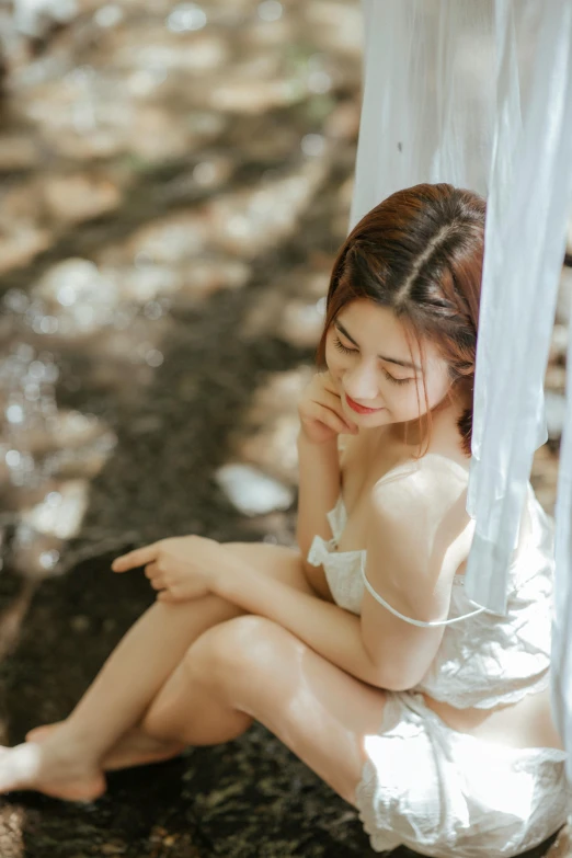 a woman with wet skin sitting on the ground