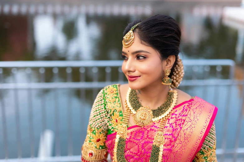 an attractive woman in traditional dress smiling and holding soing