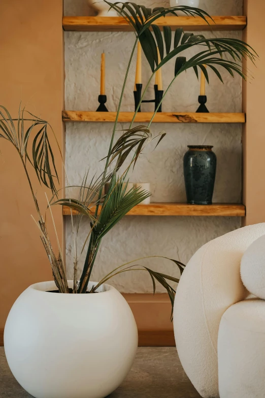 large white planters sit on the table of a neutral colored room