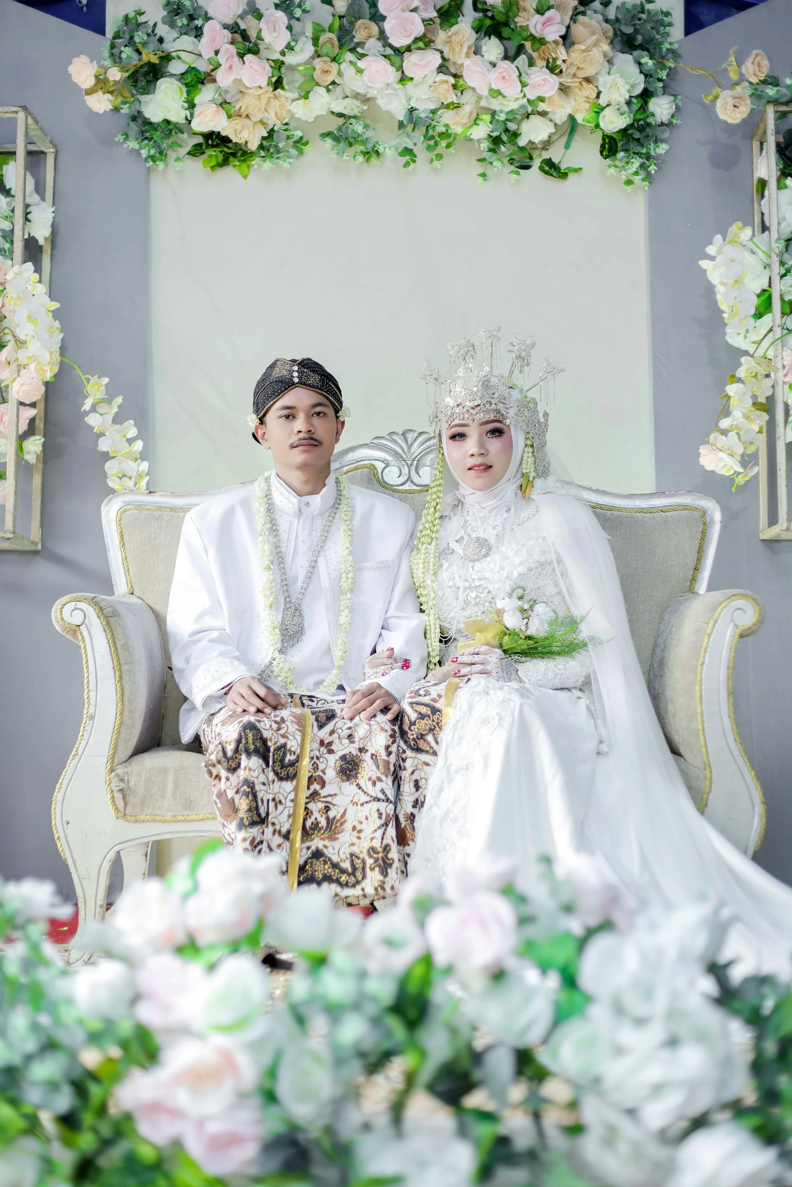 man and woman posing for a po in a white wedding dress