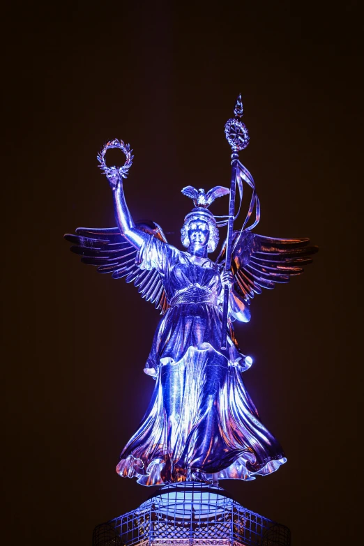a statue that is lit up in the dark