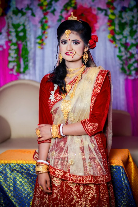 a woman in red and white wearing an indian outfit