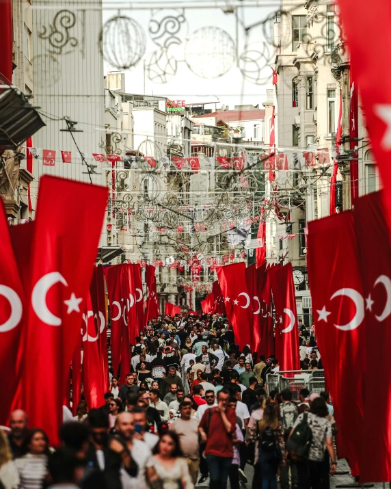 a very crowded street with many red flags