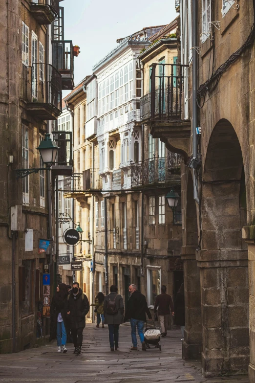 a group of people walking down a stone street