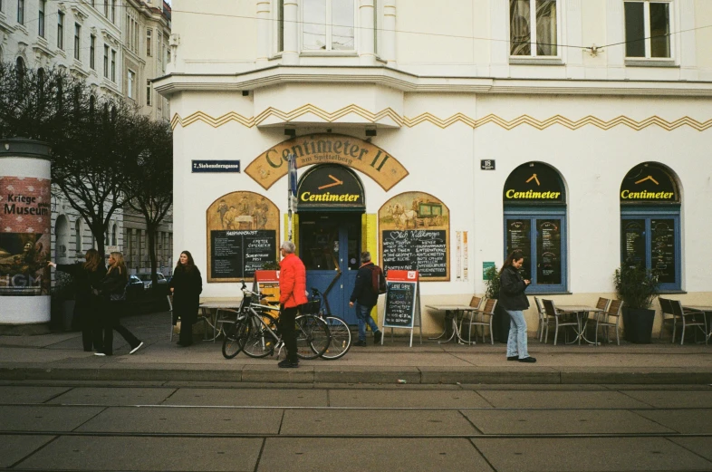 people outside a building where there is a group of bikes